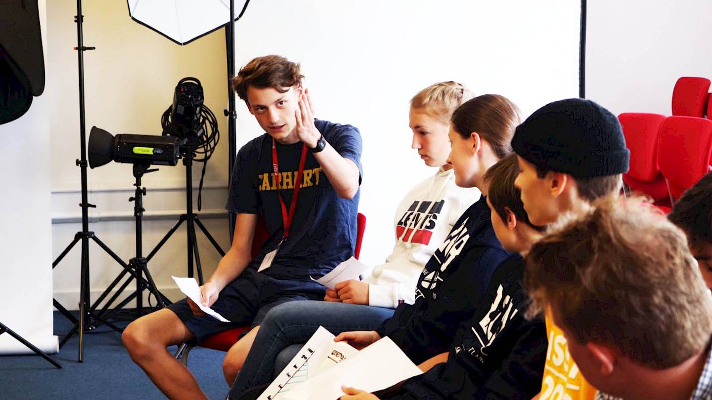 ISSFT students huddled around a laptop