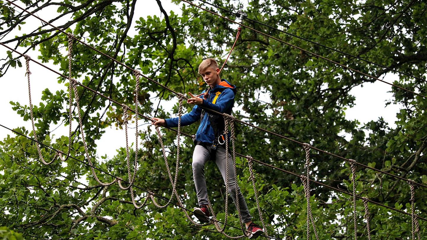 ISSFT student negotiating a treetop walkbridge