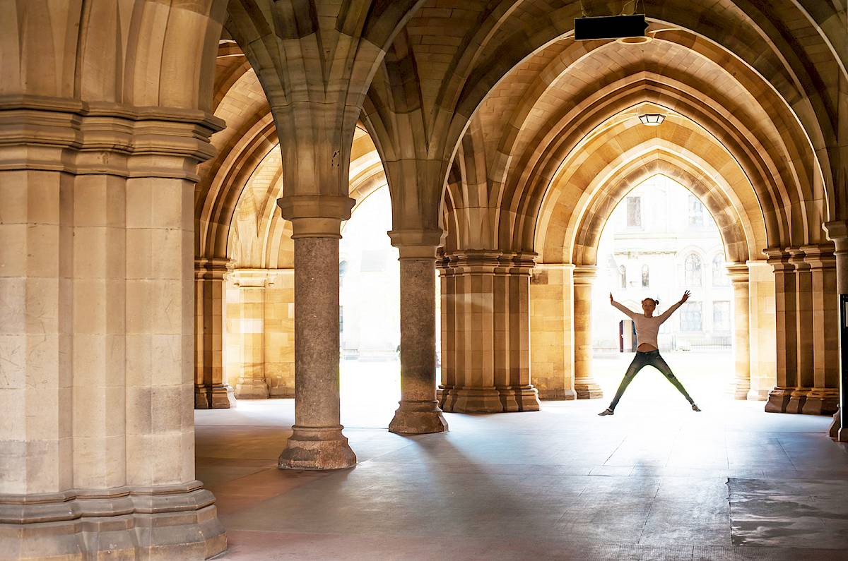ISSFT student doing a star jump at the Undercroft, Glasgow University